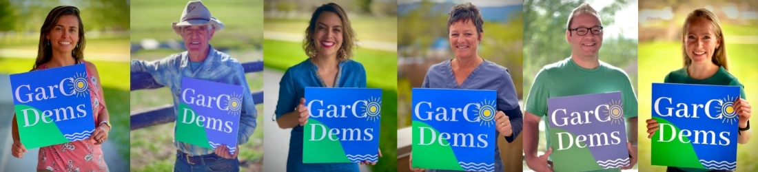 People each holding Garfield County Democrats sign